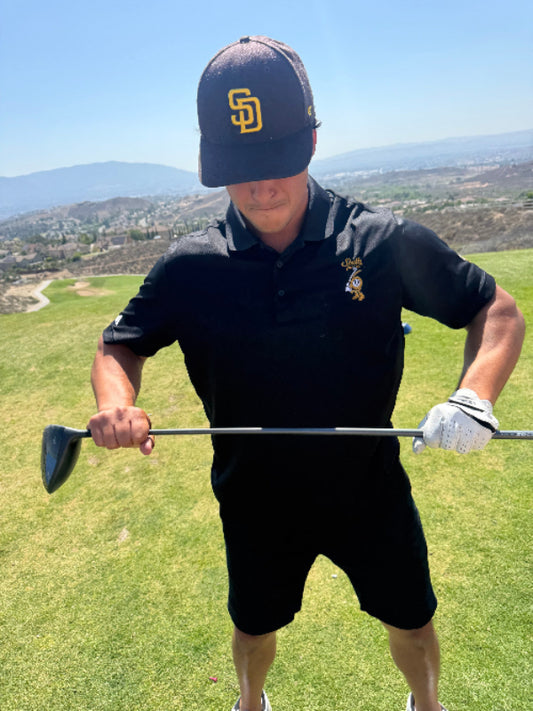 Men’s black Golf Panel Polo in large size during a round of golf.